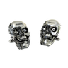 An extreme close-up of a Steampunk Skull Cufflink, emphasizing the fine details of the pyramid mechanism and engraved floral work.