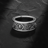 925 sterling silver lion ring with Celtic knotwork and quatrefoil patterns on dark slate background