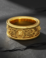 Gold tone lion ring with Celtic knot patterns and diamond shapes displayed on textured slate surface