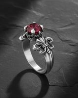 Front view of 925 silver fleur-de-lis ring showing decorative shoulder details and faceted ruby centerstone