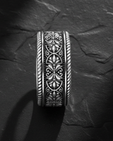 Side view of handcrafted filigree ring showing detailed botanical motifs and rope-twisted border edges