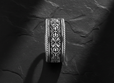 Side view of handcrafted filigree ring showing detailed botanical motifs and rope-twisted border edges