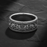 925 sterling silver filigree ring with intricate floral scrollwork displayed on textured slate background