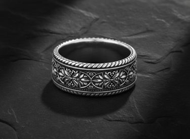 925 sterling silver filigree ring with intricate floral scrollwork displayed on textured slate background