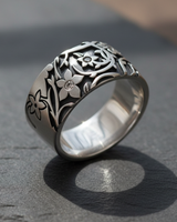 Side angle view of handcrafted floral ring showing detailed vine motifs and three-dimensional flower design