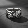 925 sterling silver floral ring with intricate botanical pattern and gemstone accents on dark slate background