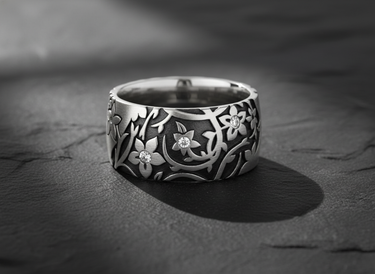925 sterling silver floral ring with intricate botanical pattern and gemstone accents on dark slate background