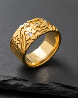 Golden version of floral ring displaying elaborate botanical carvings and sparkling gemstone details