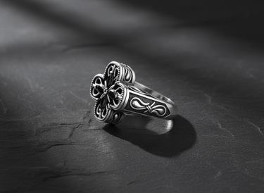 Close-up of handcrafted silver cross ring displaying intricate metalwork and oxidized finish details