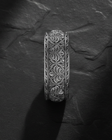 Side profile view of ornate floral ring showing detailed botanical engravings and wide band craftsmanship