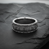 925 sterling silver floral ring with raised scrollwork and leaf border patterns displayed on dark slate surface