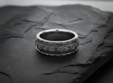 925 sterling silver floral ring with raised scrollwork and leaf border patterns displayed on dark slate surface