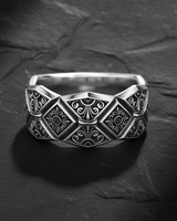 925 sterling silver geometric ring with diamond and square patterns displayed on textured slate background