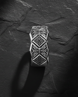 Side profile view of handcrafted geometric ring showing detailed floral motifs and oxidized silver finish