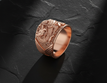 Rose gold celtic griffin ring with oxidized detailing and mythical creature design on black slate backdrop