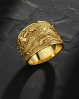 Gold finish griffin ring showing intricate feather details and geometric patterns on textured stone surface