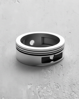 Silver Piston Ring in 925 sterling silver, showing the wide band, recessed grooves, and rectangular indentations.