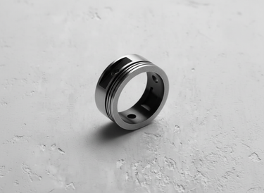 Angled shot of a men's 925 sterling silver piston ring, detailing its industrial design and polished inner band.