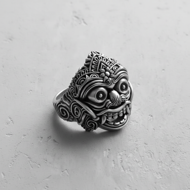 Oxidized 925 sterling silver Balinese mask ring showcasing intricate details of the wide eyes and swirling patterns.