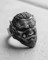 Three-quarter view of the Silver Orc Warrior Ring, highlighting its detailed braided hair, tusks, and oxidized finish.