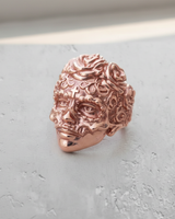 A rose-gold finish on the Silver Sugar Skull Ring, angled to display the detailed rose carvings in the hair and side profile.