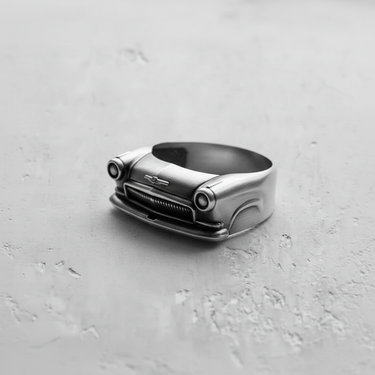 Close up of retro car front ring handcrafted in silver with oxidized details on grille and lights