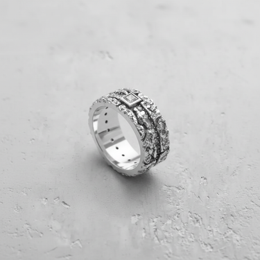 Men's textured gemstone ring in 925 sterling silver with a rough, organic finish and a central square stone, angled view.