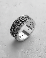 Angled close-up of the handcrafted silver textured gemstone ring, showcasing the rugged, organic metalwork and stone settings.