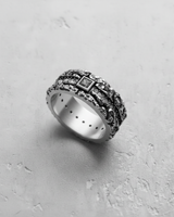 Handcrafted textured silver gemstone ring at an angle, displaying the oxidized finish that enhances its organic design.