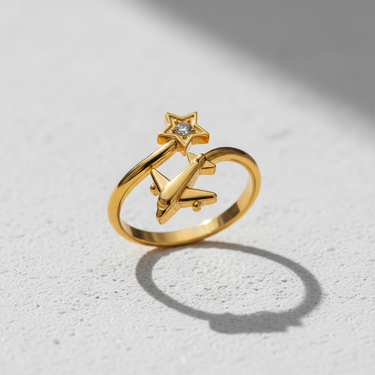 Gold vermeil silver airplane star ring with a brilliant central gemstone, showcasing its adjustable open band design on a white surface.