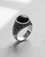 Angled view of the men's silver basketweave cabochon ring, highlighting the oxidized finish and the smooth, domed black gemstone.