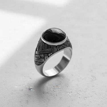 Angled view of the men's silver basketweave cabochon ring, highlighting the oxidized finish and the smooth, domed black gemstone.