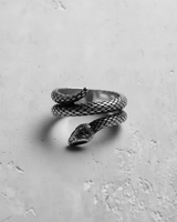 Sterling silver snake ring in a black and white photo, showing the serpentine wrap and intricate scale pattern.