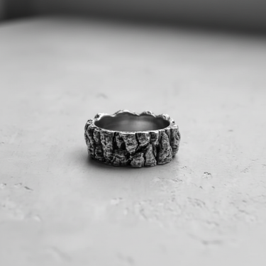 Side view of the handcrafted Silver Mountain Ring, showcasing the detailed, organic tree bark-like texture and uneven edges.