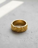 14K gold vermeil Silver Mountain Ring with a rugged, craggy rock texture, shown on a neutral grey concrete surface.