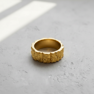 14K gold vermeil Silver Mountain Ring with a rugged, craggy rock texture, shown on a neutral grey concrete surface.