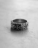 Black and white photo of the sterling silver cross ring, highlighting the deep, rugged texture and the carved cross design.