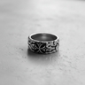 Black and white photo of the 925 sterling silver cross ring, focusing on the detailed stylized cross and rugged, textured band.