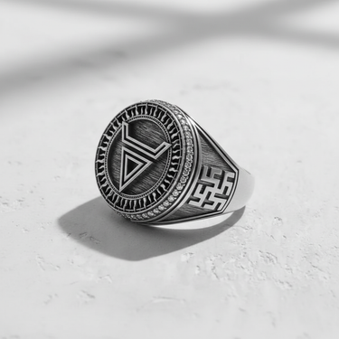 Oxidized 925 sterling silver geometric ring with side knotwork pattern, highlighted by strong shadow on a white background.
