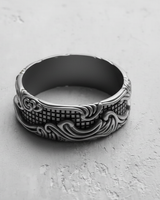 Top-down close-up of the handcrafted silver wave grid ring, emphasizing the intricate metalwork and wide band design.