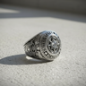 Angled view of the Silver Air Force Academy ring highlighting the 'United States' text and central compass rose design.
