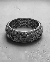 Top-down view of the handcrafted Dragon Phoenix Ring in 925 silver, highlighting the unique interior honeycomb pattern and band width.