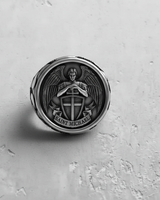 Handcrafted 925 sterling silver Saint Michael ring with a close-up on the face detailing the 'SAINT MICHAEL' banner.