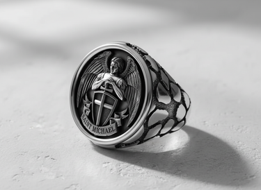 Angled view of the sterling silver Saint Michael ring, highlighting the oxidized details and unique textured band.