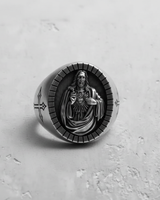 Top-down view of the sterling silver Sacred Heart Jesus ring, showing the detailed oval face and notched border.