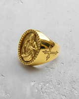 Gold vermeil Jesus signet ring featuring Sacred Heart relief and fluted bezel on textured white background