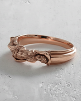 Silver Goddess Ring with a polished rose gold plating, showcasing the detailed reclining female figure on a white surface.