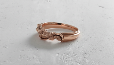 Silver Goddess Ring with a polished rose gold plating, showcasing the detailed reclining female figure on a white surface.