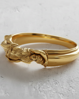 14K gold vermeil goddess ring featuring a detailed reclining female figure on a textured white surface.