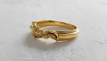 14K gold vermeil goddess ring featuring a detailed reclining female figure on a textured white surface.